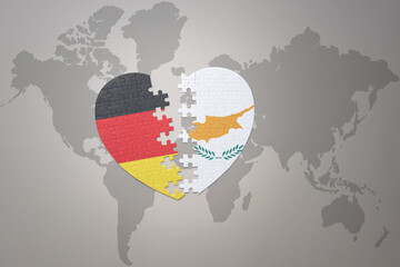 puzzle heart with the national flag of cyprus and germany on a world map background. Concept.