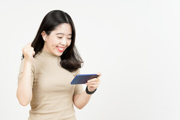 Fototapeta premium Playing Mobile Game on Smartphone Of Beautiful Asian Woman Isolated On White Background