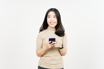 Fototapeta premium Smiling and Holding Smartphone Of Beautiful Asian Woman Isolated On White Background