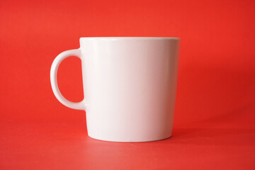 empty white cup on red background