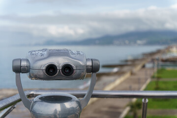 A selective focus shot of binoculars on a seaside. Selective focus.