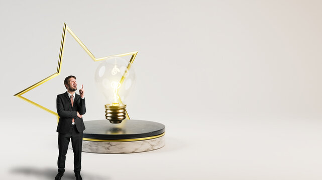 businessman and a lightbulb on a stage with a golden star in front of light grey background