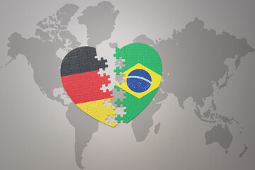 puzzle heart with the national flag of brazil and germany on a world map background. Concept.