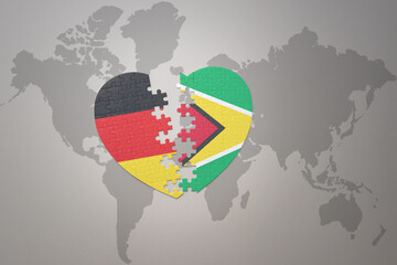 puzzle heart with the national flag of guyana and germany on a world map background. Concept.