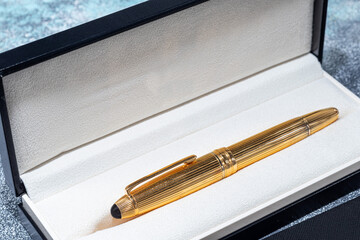 Fountain pen on a marble and gray background. Selective focus.