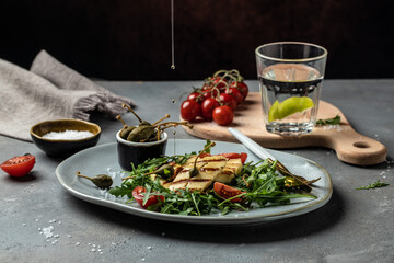 vegeterian salad with fried halloumi and tomatoes, closeup, keto ketogenic diet. Delicious breakfast or snack, Clean eating, dieting, vegan food concept. top view