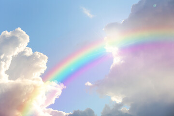 Fototapeta na wymiar Beautiful view of bright rainbow in blue sky on sunny day