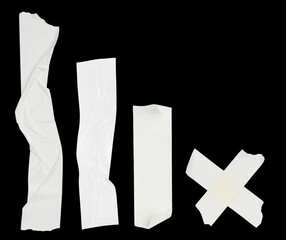 Set with pieces of white adhesive tapes on black background, flat lay