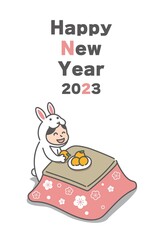 こたつでくつろぐウサギの着ぐるみを着た女性(2023年うさぎ年の年賀状)
