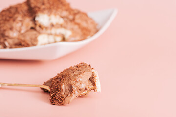 Piece of cake on cake fork on the background.