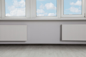 Fototapeta premium Modern office with window and radiators. Interior design