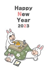 こたつでくつろぐウサギの着ぐるみを着た3人家族(2023年うさぎ年の年賀状)