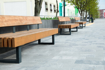 Paved city street with comfortable wooden benches