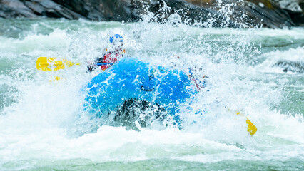 Big splash during whitewater rafting trip on the river in Norway