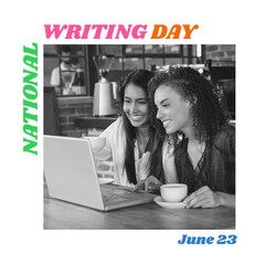 National writing day text by happy biracial female friends using laptop sitting with coffee at cafe