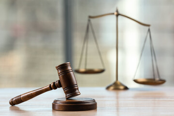 Wooden gavel and scales of justice on table indoors. Space for text