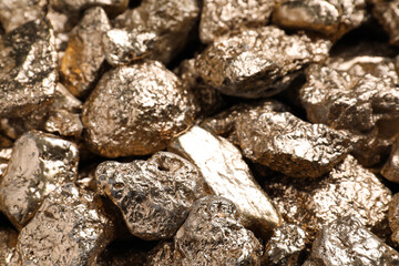 Pile of gold nuggets as background, closeup