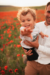 Father and son in a poppy field