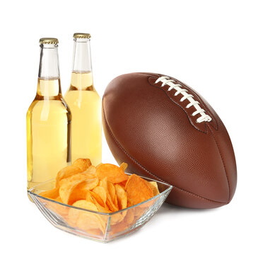 American football ball, beer and chips on white background