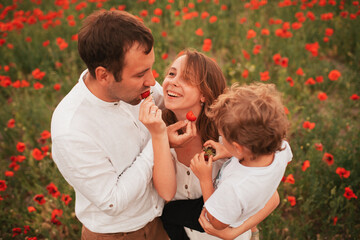 Beautiful family in a poppy field.