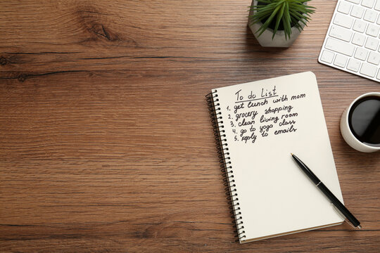 Flat lay composition with to do list on wooden table, space for text