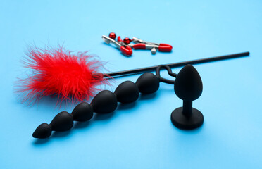 Sex toys and accessories on light blue background