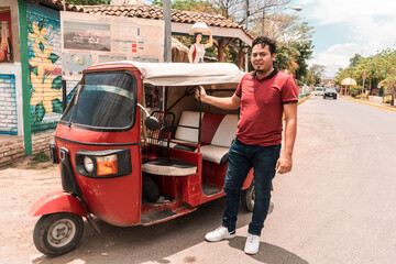 Motorcycle taxi driver in the municipality of La Paz Centro Nicaragua. Self-employed worker in his vehicle. Concept of transportation in towns