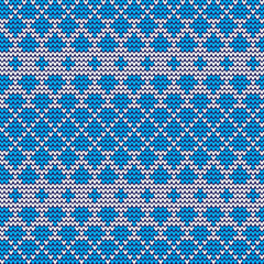 Knitted blue and white pattern. Geometric shapes triangles, rhombuses.