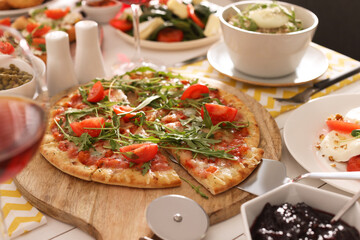 Pizza and many different dishes served on buffet table for brunch