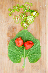 naga chili over on calabash leaf over on background