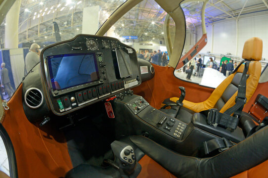 Cockpit of a light sport plane dashboard, steering wheel, pilot and passenger seats.