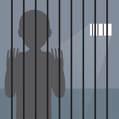 Silhouette of a prisoner inside a prison behind bars