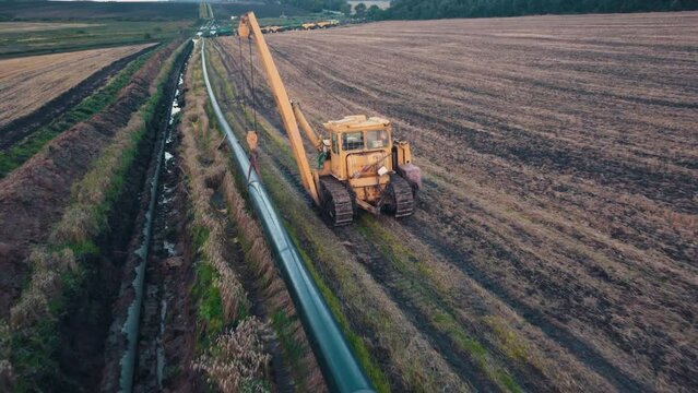 In the pipeline repairs. Construction of the blue pipeline. Gas pipe. Construction of the pipeline. Pipeline building. Construction machinery laying pipe in the ground.