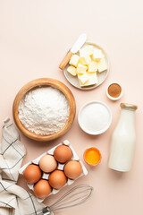 Baking ingredients for cakes bread cookies or pastry on beige background. Top view vertical...