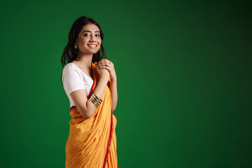 Young indian woman wearing sari smiling at camera