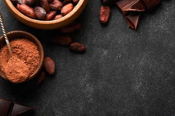 Chocolate truffles with cocoa powder in wooden dish on old dark concrete table background. Tasty sweet chocolate truffles candies. Valentines Day and Mothers Day concept with copy space. Top view.