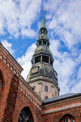 Riga, Latvia, 14 October 2021: St. Peter's church or cathedral with clock and bell tower, parish church of the Evangelical Lutheran, Northern Gothic Style with octagonal spire, tallest spire