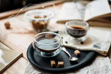 Coffee in glass cup on wooden background