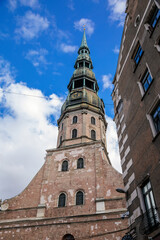 Riga, Latvia, 14 October 2021: St. Peter's church or cathedral with clock and bell tower, parish church of the Evangelical Lutheran, Northern Gothic Style with octagonal spire, tallest spire