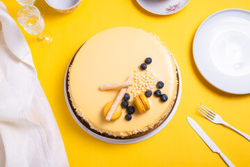 Passion fruit mousse cake on yellow background