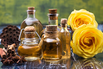 cosmetic rose oil bottles and yellow roses