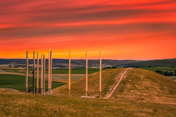 Fototapeta premium View towards the famous Celtic grave at the Glauberg in Glauburg/Germany under a red sky
