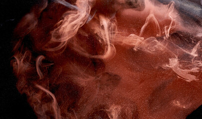 Orange smoke on black ink background, colorful fog, abstract swirling touch ocean sea, acrylic paint pigment underwater