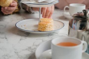 Tea with scones and clotted cream, jam, strawberries on the white table