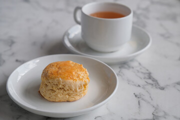 Tea with scones and clotted cream, jam, strawberries on the white table