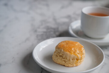 Tea with scones and clotted cream, jam, strawberries on the white table