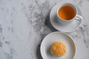 Tea with scones and clotted cream, jam, strawberries on the white table