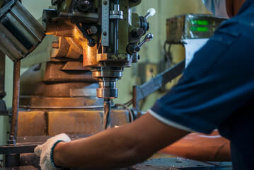 The machine operator working t NC milling machine.