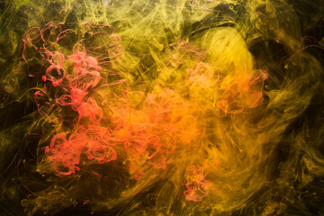 Fototapeta na wymiar Yellow smoke on black background, colorful fog, abstract swirling ink ocean sea, acrylic paint pigment underwater