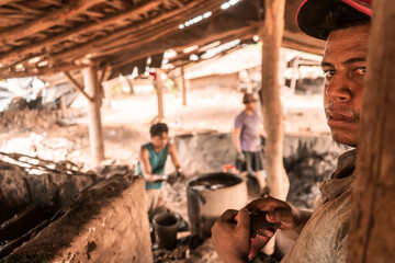 Workers in a brick and clay tile manufacturing workshop in La Paz, Central Nicaragua. Concept of...